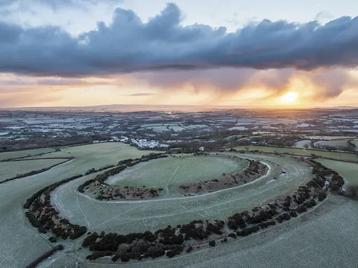 Framed Print : Aerial view of winter sunrise above Warbstow Bury, an Iron Age Hillfort near Davidstow in Cornwall, England. Winter (January) 2024