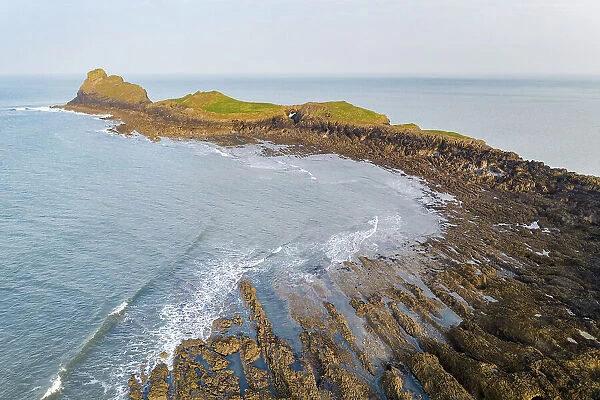 Aerial view of Worm's Head promontory on the Gower Peninsula, South Wales, UK. Spring (March) 2022