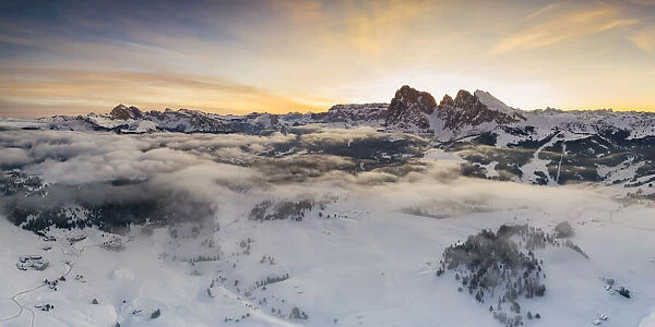 Aerial views of the Alpe di Siusi (Seiser Alm) with the peaks of Sassolungo