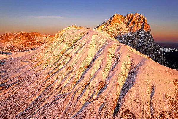 Aerial winter snowy massif of Gran Sasso (Corno Grande) and Aquila mountain, Campo Imperatore, Gran Sasso e Monti della Laga National Park, L'Aquila province, Abruzzo, Italy