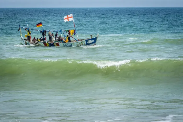 Framed Print : Africa, Benin, Grand Popo. A colorful fishing boat coming back home