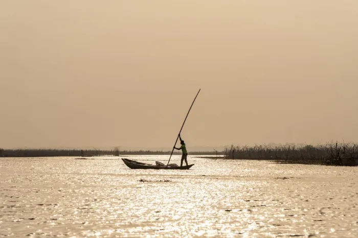 Framed Print : Africa, Benin, Lake Nokoua. A fisherman in his typical wooden canoe near to