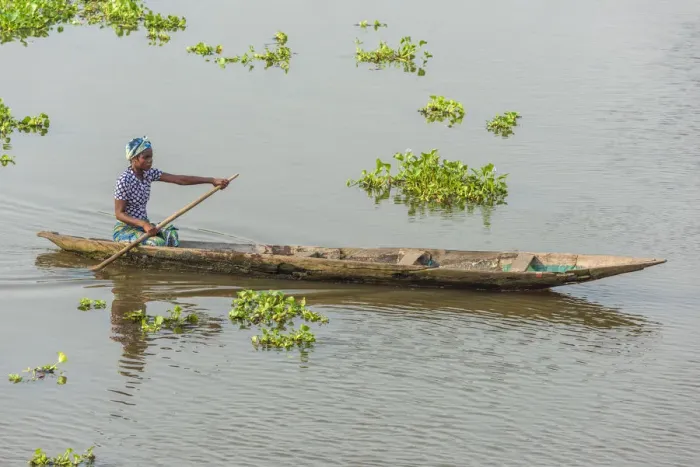 Framed Print : Africa, Benin, Lake Nokoua. A woman in her traditional wooden boat in the famous Framed Print : Africa, Benin, Lake Nokoua. A woman in her traditional wooden boat in the famous