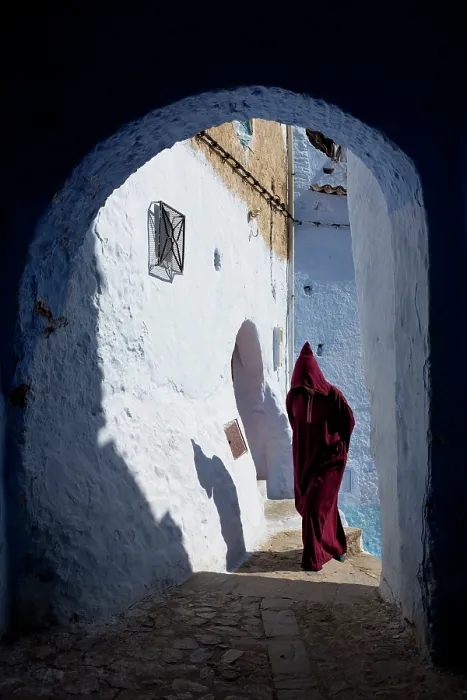 Framed Print : Africa, Morocco, Rif Mountains, Chefchaouen, Traditionally dressed berber walking through a passageway Framed Print : Africa, Morocco, Rif Mountains, Chefchaouen, Traditionally dressed berber walking through a passageway