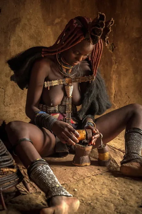 Framed Print : Africa, Namibia, Kamanjab. A himba woman preparing the smoke to deodorize herself Framed Print : Africa, Namibia, Kamanjab. A himba woman preparing the smoke to deodorize herself