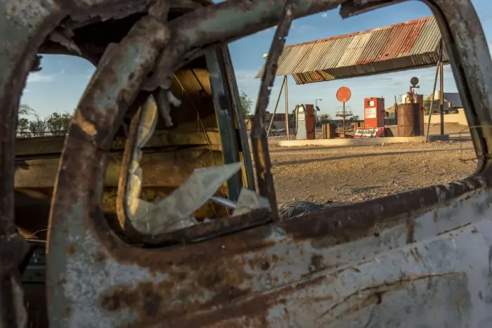Framed Print : Africa, Namibia, Keetmanshop. Old petrol station seen through a rusty car door Framed Print : Africa, Namibia, Keetmanshop. Old petrol station seen through a rusty car door