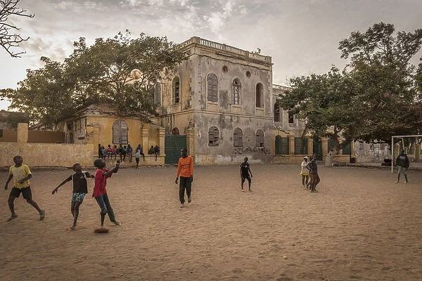 Africa, Senegal, Dakar. children playing football at sunset on the island Gora e