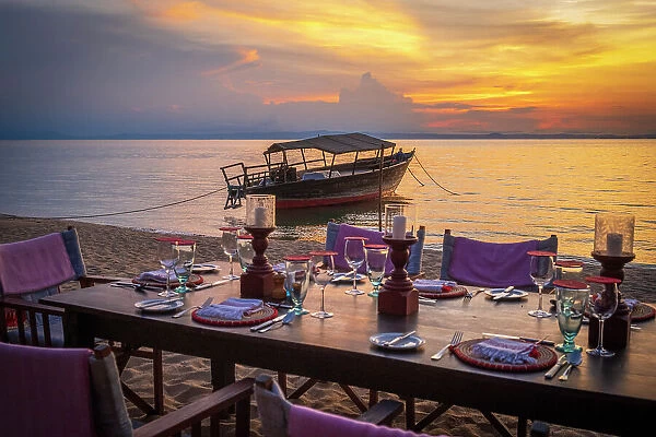 Africa, Tanzania, Mahale Mountains National Park. Sunset on Lake Tanganyika with the dining table on the beach