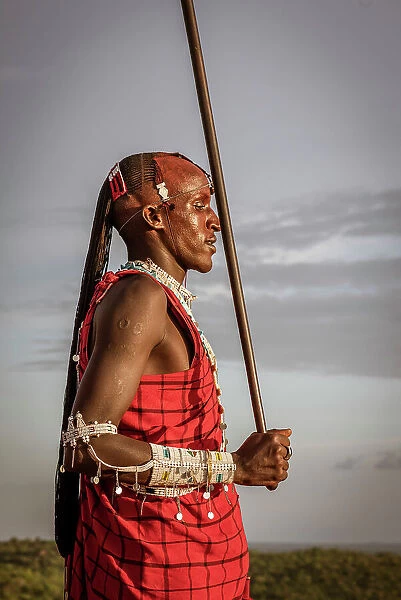 Africa, Tanzania, Manyara Region. Msai warrior posing with his traditional stick