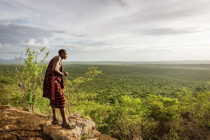 Framed Print : Africa, Tanzania, Manyara Region. Msai man on a rock overlooking the landscape towards the plain of Tarangire National park