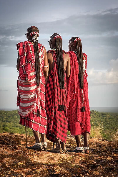 Africa, Tanzania, Manyara Region. Msai warriors on a rock showing their traditional braids