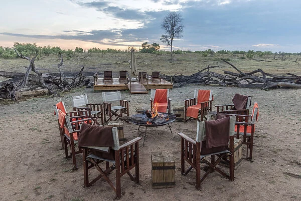africa, Zimbabwe, Hwange National park. Camp chairs set up round the fire first thing