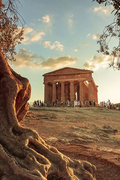 Agrigento, Sicily. Tourists visiting Concordia Temple in the Valley of Temples at sunset