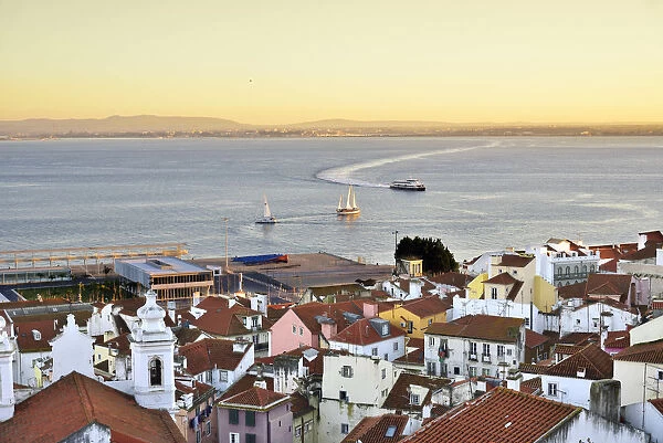 Alfama district at twilight facing the Tagus river. Lisbon, Portugal