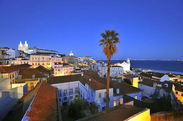 Alfama at dusk, seen from the Portas do Sol belvedere. Lisbon, Portugal