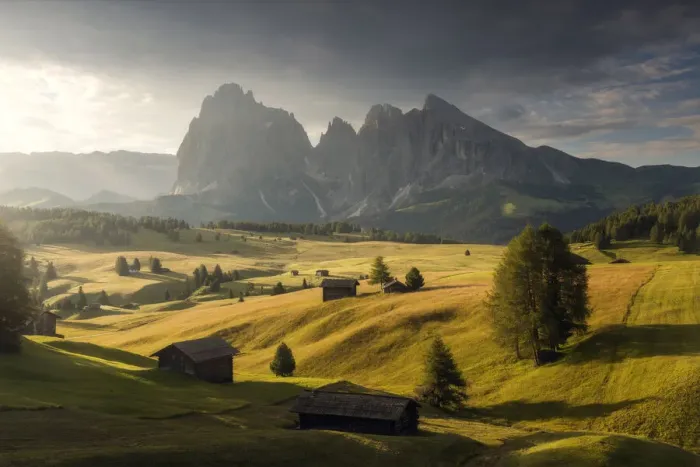 Framed Print : Alpine meadow and wooden huts in the Dolomites, Italy