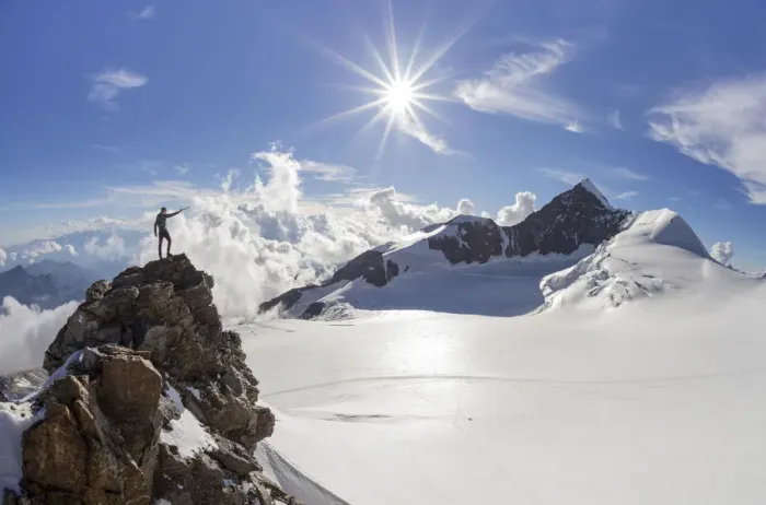 Framed Print : Alpinist over a rock near Balmenhorn bivac looking to Lyskamm peak with sun in backlight Framed Print : Alpinist over a rock near Balmenhorn bivac looking to Lyskamm peak with sun in backlight