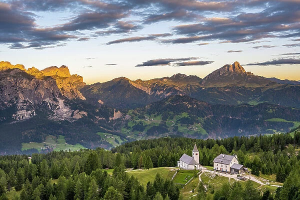 Alta Badia, Bolzano province, South Tyrol, Italy, Europe. The pilgrimage church La Crusc and the La Crusc refuge at sunrise