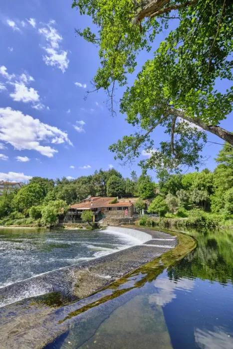 Framed Print : The Alva river at Coja with a restaurant on a old building on the riverside