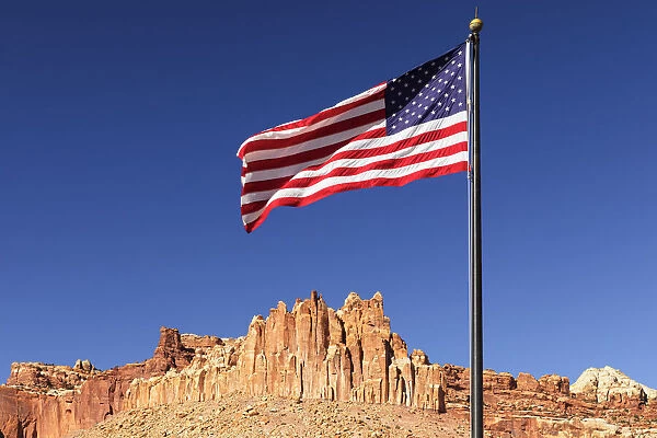American flag and Waterpocket Fold rock formation, Capitol Reef National Park, Utah, USA