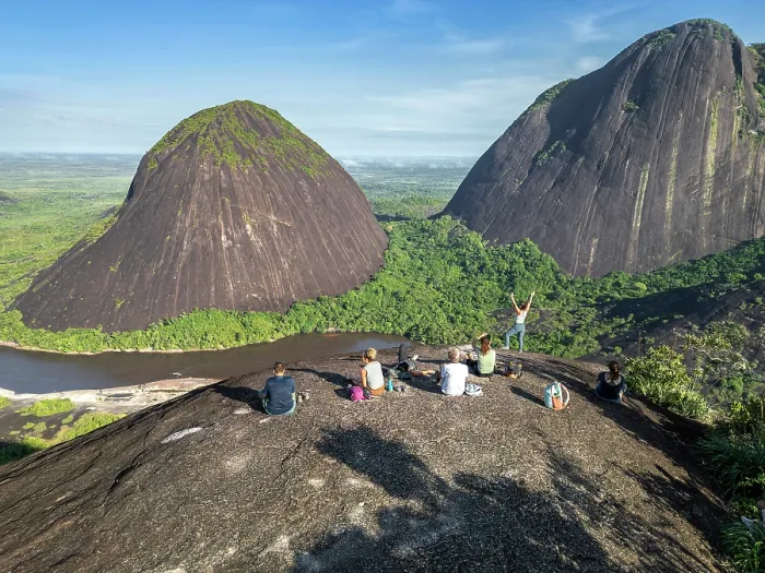 Framed Print : Americas, South America, Colombia, Puinave Indigenous Reserve, aerial view of the Cerros de Mavecure mountains; hikers sitting on the summit