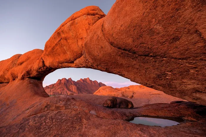 Framed Print : Ancient granite mountains and natural rock arch at dusk, Spitzkoppe, Namib Desert, Namibia Framed Print : Ancient granite mountains and natural rock arch at dusk, Spitzkoppe, Namib Desert, Namibia