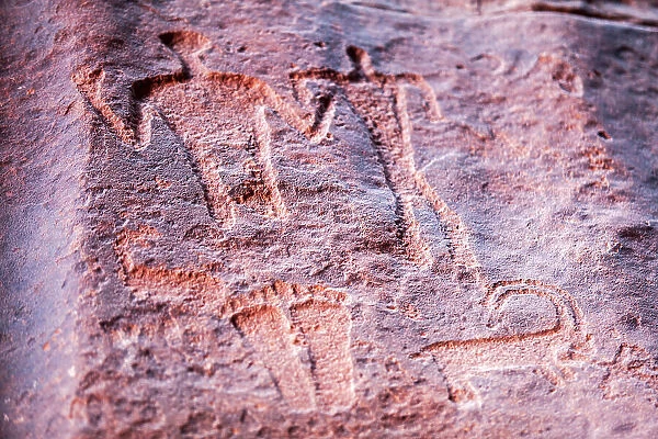 Ancient prehistoric petroglyphs on a rock of the Wadi Rum desert, Aqaba, Jordan. Declared a UNESCO World Heritage Site since 2011