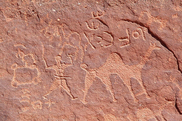 Ancient prehistoric petroglyphs on a rock of the Wadi Rum desert, Aqaba, Jordan, Middle East. Declared a UNESCO World Heritage Site since 2011