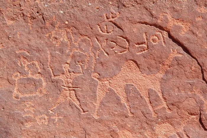 Framed Print : Ancient prehistoric petroglyphs on a rock of the Wadi Rum desert, Aqaba, Jordan, Middle East. Declared a UNESCO World Heritage Site since 2011