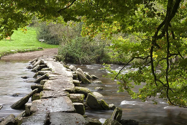 Ancient Tarr Steps clapper bridge crossing the River Barle in Exmoor National Park