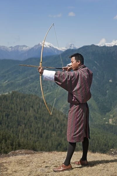 Archery, datse, is a favourite national sport of the Bhutanese. Here an Archer practices his skills on the high Cheli La Pass using a traditional bamboo bow and arrow. Modern American-made bows are now used in