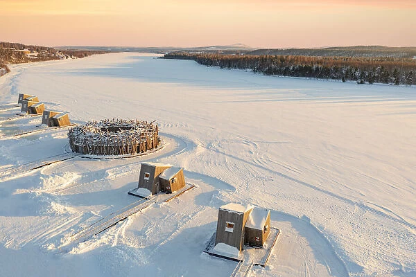 Arctic Bath Hotel and its wood cabins in the snow at sunset, Harads, Lapland, Sweden