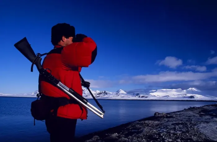 Framed Print : Armed guide checking for polar bears prior to land excursion Framed Print : Armed guide checking for polar bears prior to land excursion