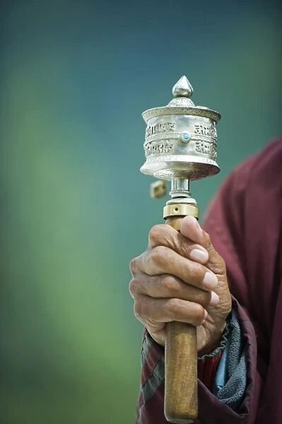 Asia, Bhutan, Thimphu, Pilgrim with a prayer wheel at the National Memorial Chorten