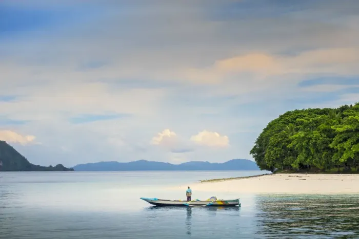 Framed Print : Asia, Indonesia, Spice Islands, Ambon, Malona Island, a local fisherman in front of a Framed Print : Asia, Indonesia, Spice Islands, Ambon, Malona Island, a local fisherman in front of a