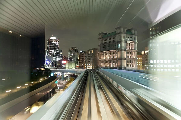 Asia, Japan, Honshu, Tokyo, POV blurred motion of Tokyo buildings from a moving train
