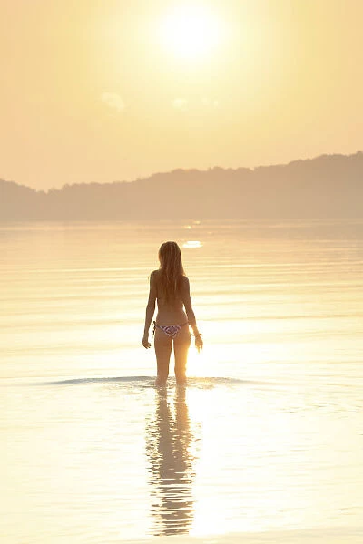 Asia, South East Asia, Cambodia, Koh Rong Samloem island, woman in a bikini silhouetted