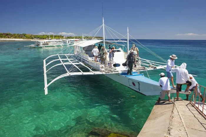 Framed Print : Asia, South East Asia, Philippines, Visayas, Cebu, tourists disembarking from an outrigger Framed Print : Asia, South East Asia, Philippines, Visayas, Cebu, tourists disembarking from an outrigger