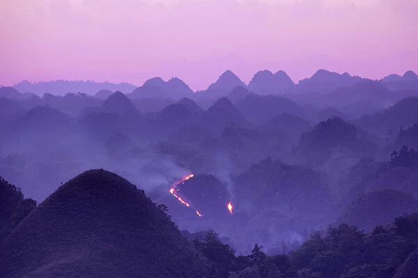 Asia, South East Asia, Philippines, Visayas, Bohol, a forest fire on the chocolate hills