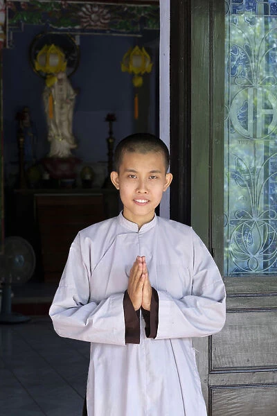 Asia, South East Asia, Vietnam; Hue; a Vietnamese Buddhist nun with her hands held