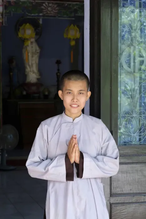 Framed Print : Asia, South East Asia, Vietnam; Hue; a Vietnamese Buddhist nun with her hands held Framed Print : Asia, South East Asia, Vietnam; Hue; a Vietnamese Buddhist nun with her hands held