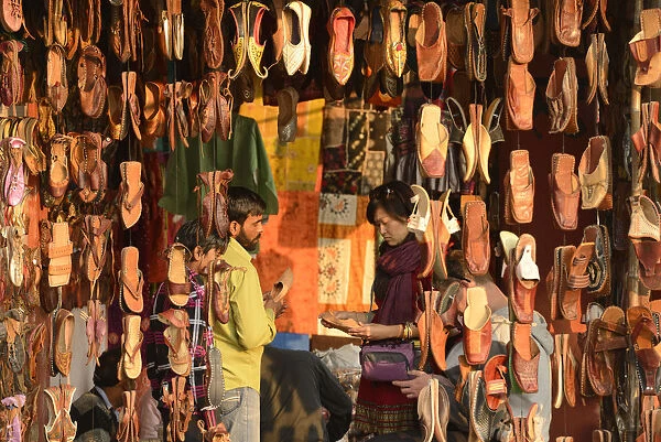 Asian woman buying shoes in market, Jaipur, India, Asia