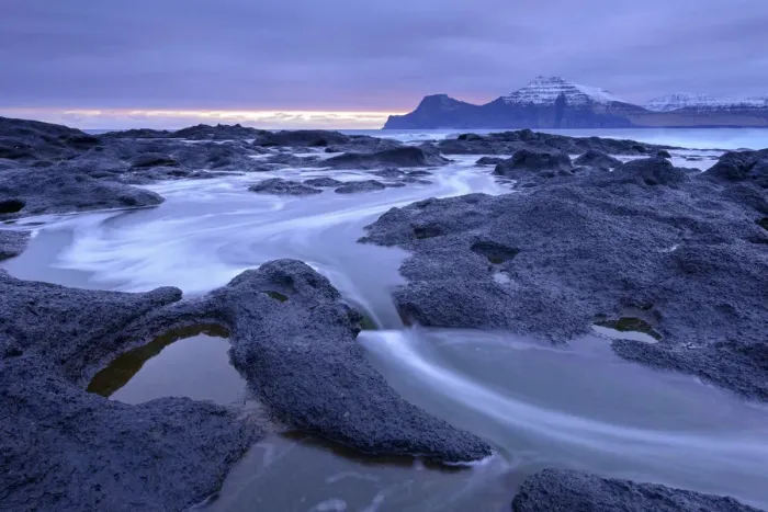 Framed Print : Atlantic waves surge over the black basalt ledges at Gjogv on the island of Eysturoy Framed Print : Atlantic waves surge over the black basalt ledges at Gjogv on the island of Eysturoy