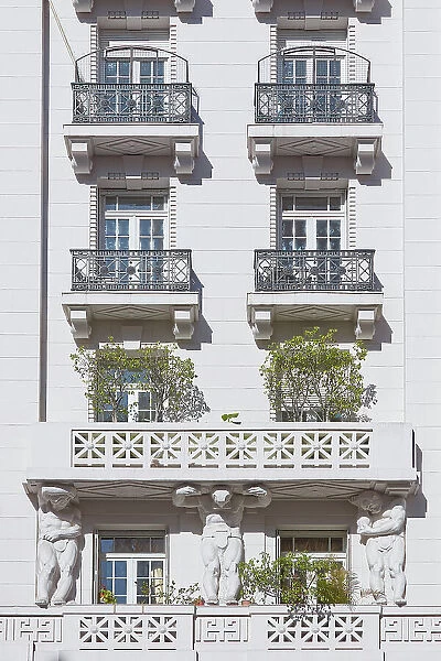 Atlas sculptures on a balcony of the Ateneo Grand Splendid Library's exterior facade, Recoleta, Buenos Aires, Argentina