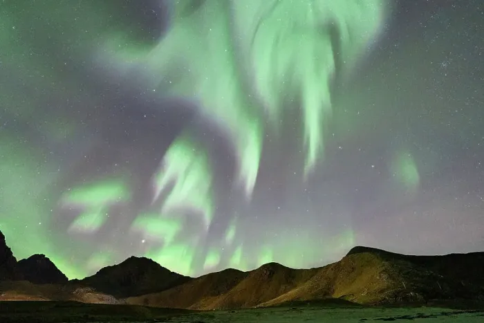 Framed Print : Aurora Borealis glowing over mountains, Haukland, Lofoten Islands, Norway Framed Print : Aurora Borealis glowing over mountains, Haukland, Lofoten Islands, Norway