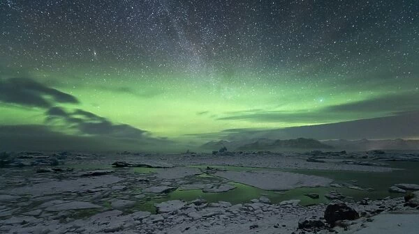 Aurora Borealis and Milky Way in the night sky above Jokulsarlon glacial lagoon, Iceland, Europe