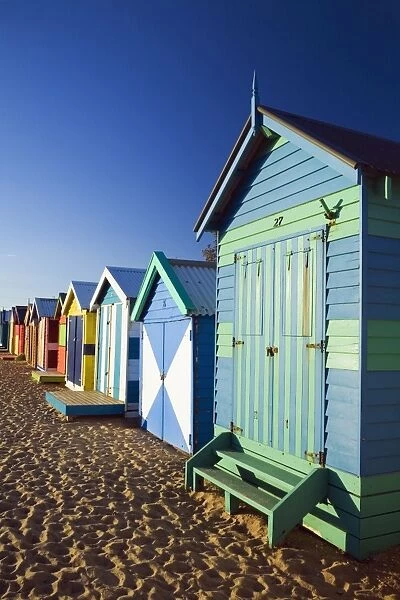 Australia, Victoria, Melbourne. Colourful beach huts at Brighton Beach