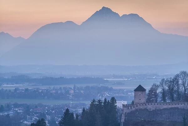 Austria, Salzburgerland, Salzburg, Richterhohe fortress and mountains, winter. dusk