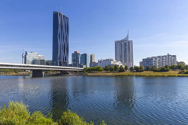 Austria, Vienna, Donau City reflecting in New Danube River