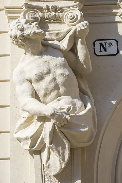 Austria, Vienna, Historic centre, Male statue on the facade of a building